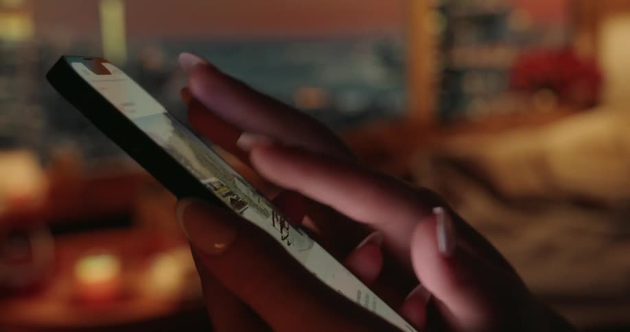 A persons fingers touching and scrolling a cell phone screen
