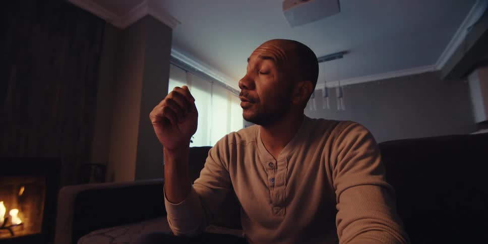 A man is talking as he sits in front of a laptop