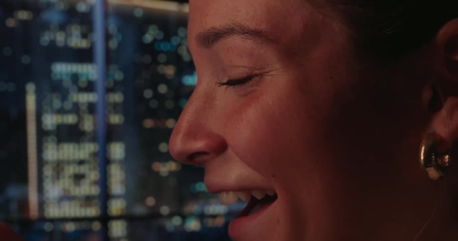 Side closeup of a girl inside a home laughing