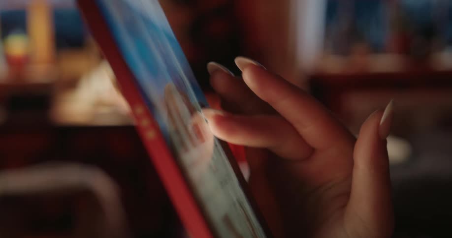 A hand scrolls through a phone