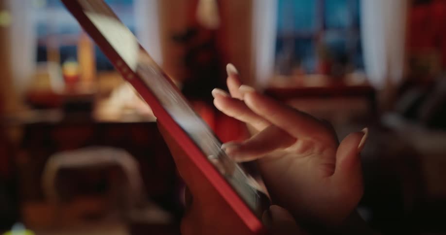A woman is tapping and sliding on her tablet