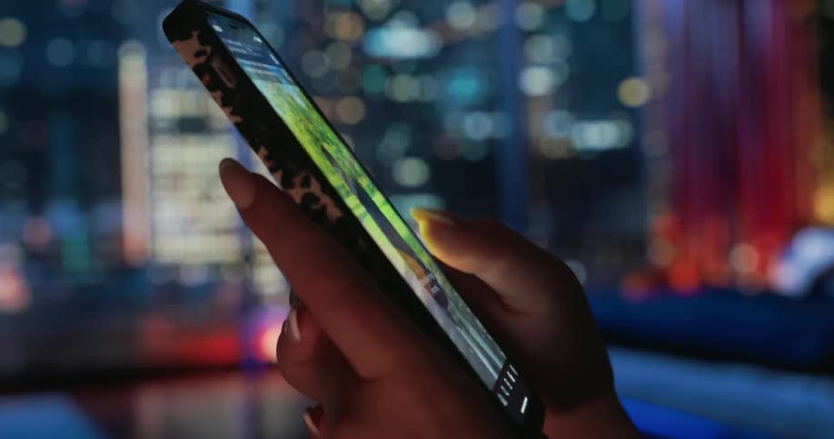 Pair of hands scrolling on a smartphone