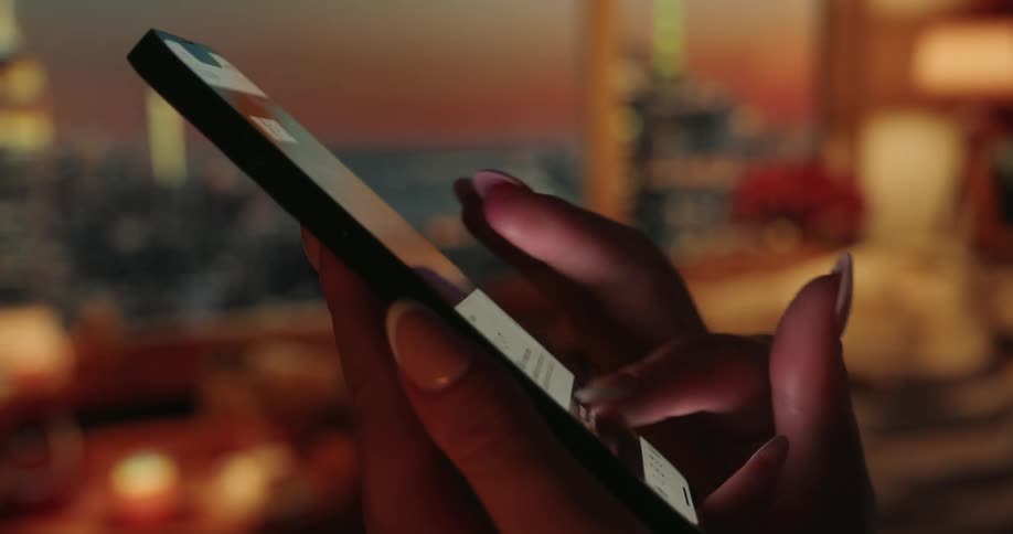 The fingers of an human hand scrolling and touching a bright smart phones screen
