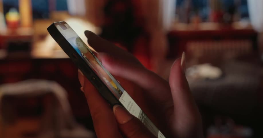 A woman is scrolling on her cellphone