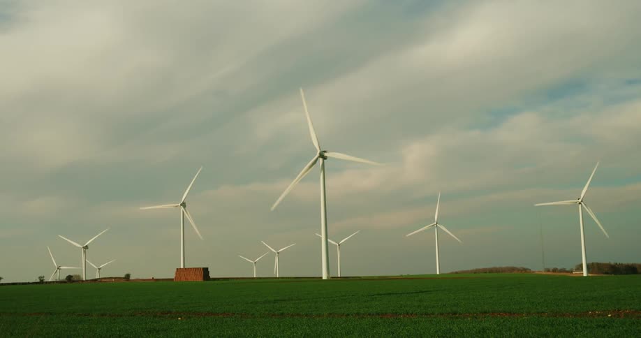 Agricultural field with wind turbines on a cloudy day