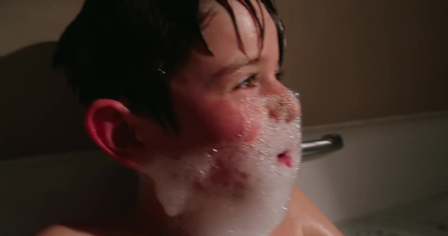 A footage of a boy playing in the jacuzzi