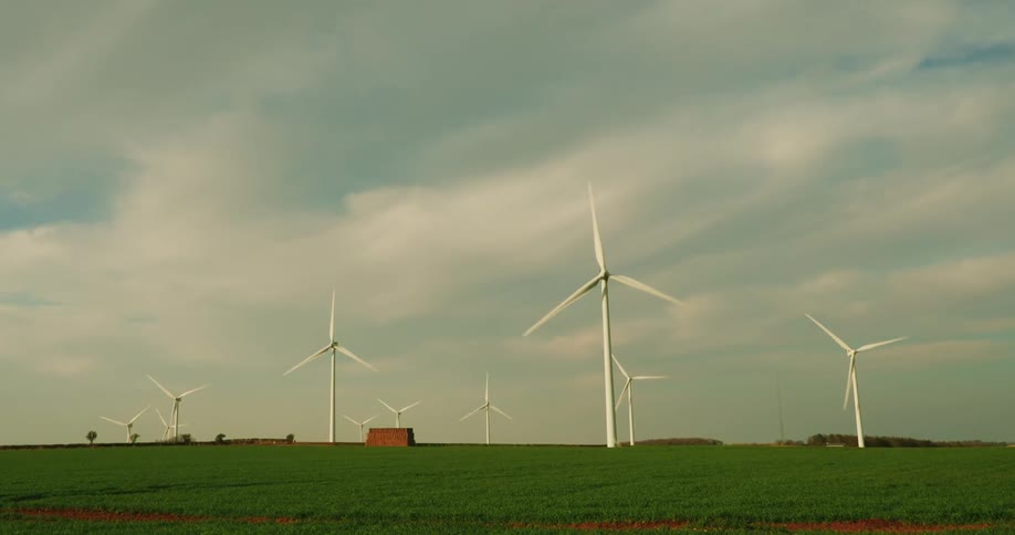 Group of wind turbines rotating on a wind farm generating energy