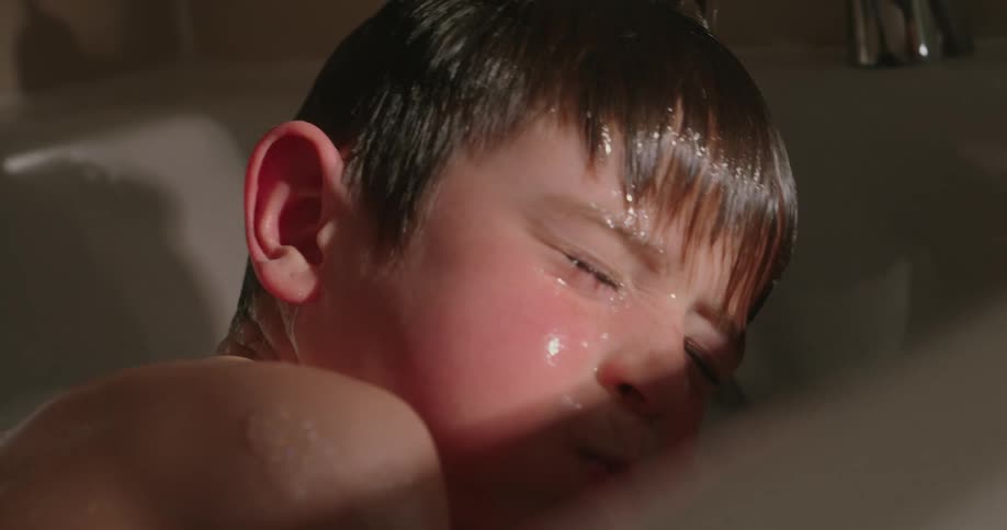 A footage of a boy bathing in the jacuzzi
