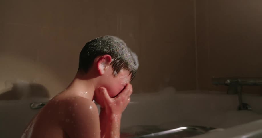 Boy taking a bath in the bathtub with foam