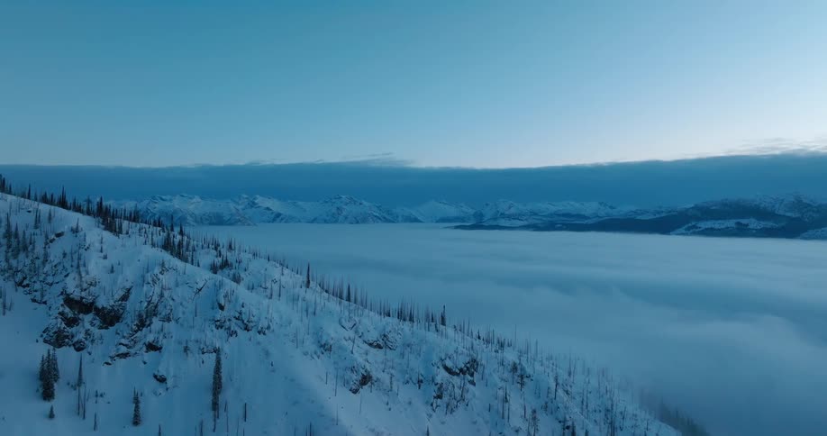 Aerial landscape of snowy mountains at dawn