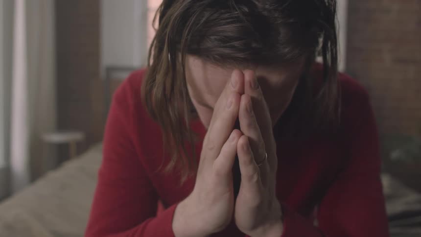 A man is praying at home