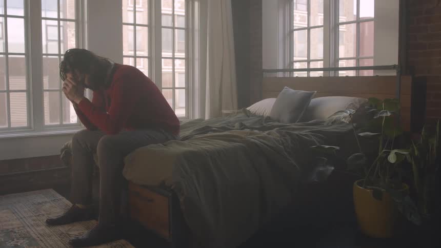 A footage of a man brooding in the room