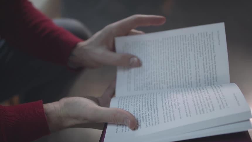 A footage of a person reading a book