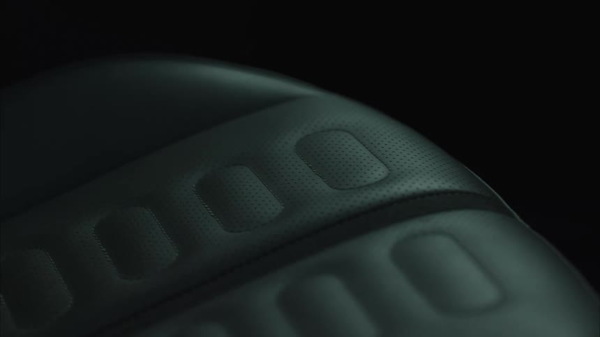 A close up of the detailed texture of a leather car seat