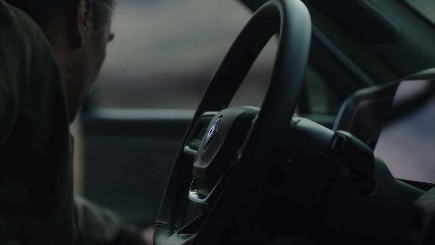 A man opens and closes his car door