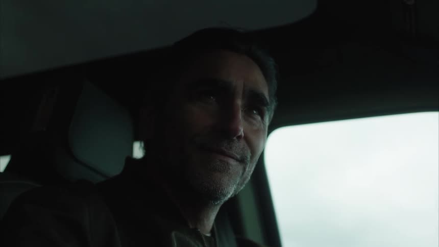 Man with happy facial expression driving a vehicle