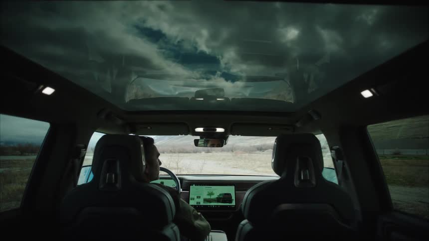 A man uses the touch screen on his dash