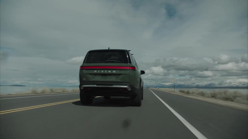 Large suv vehicle traveling along a seaside road
