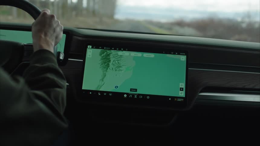 Person zooming in on a car display to better see the road map