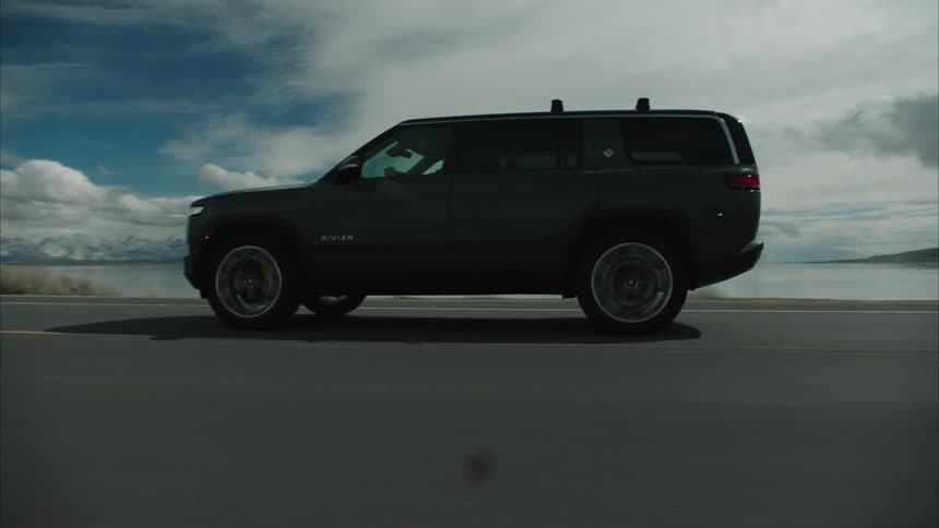 A vehicle is driving on the highway on a cloudy day