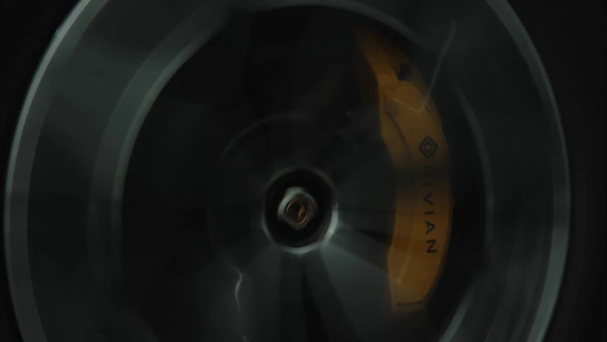 The chrome wheel spins as the vehicle drives on the road
