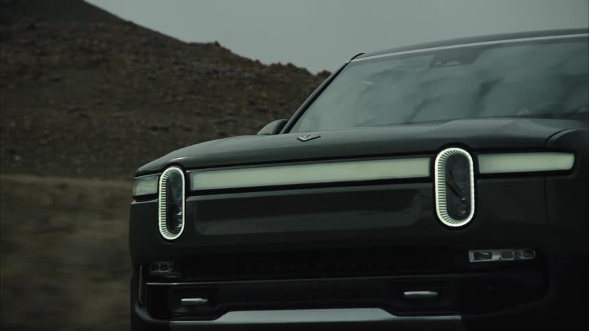 Closeup to the nose of a car driving down the road
