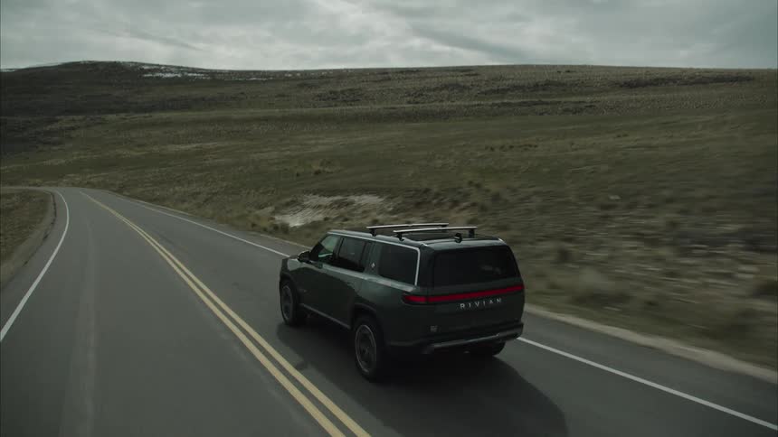 An aerial footage of a car moving along the highway