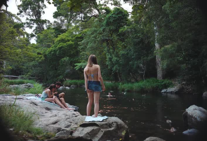 People having fun in a lake surrounded by trees