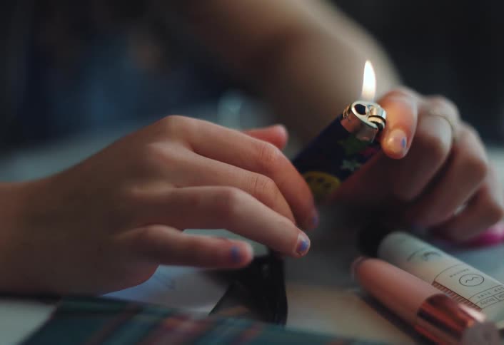 A footage of a person holding a lighter