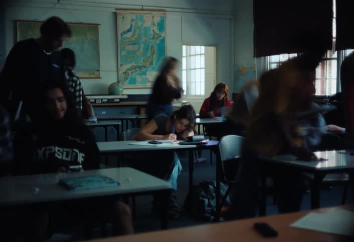Lonely woman studying in a room and then other students come in and sit down