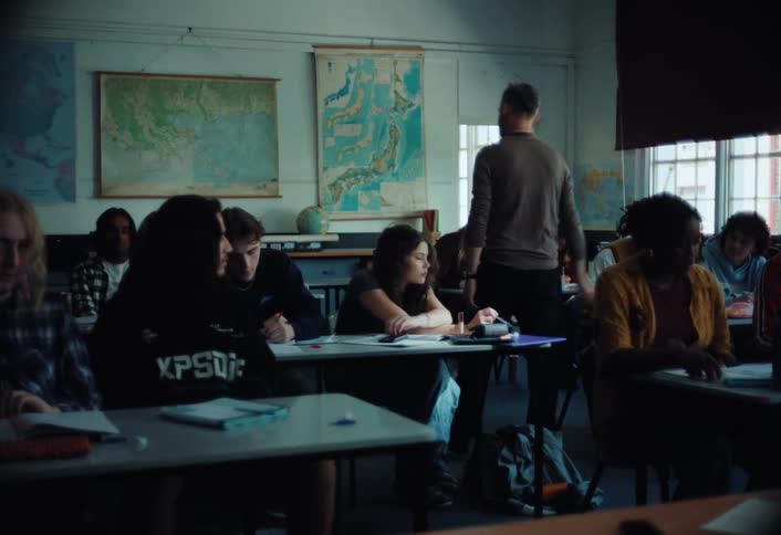 A teacher walks past the students at their desks