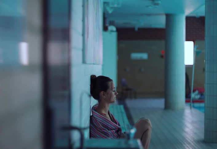 Girl sitting on the floor with lost sad look