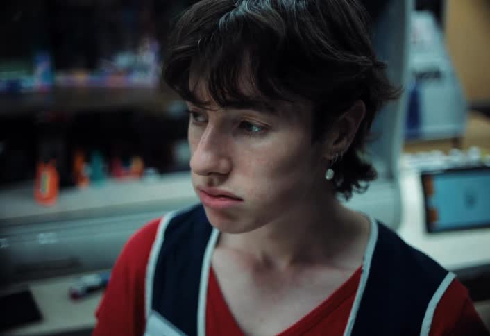 Person sighs whiles standing in the checkout area of a store