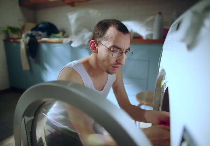 A man is searching for something in the dryer