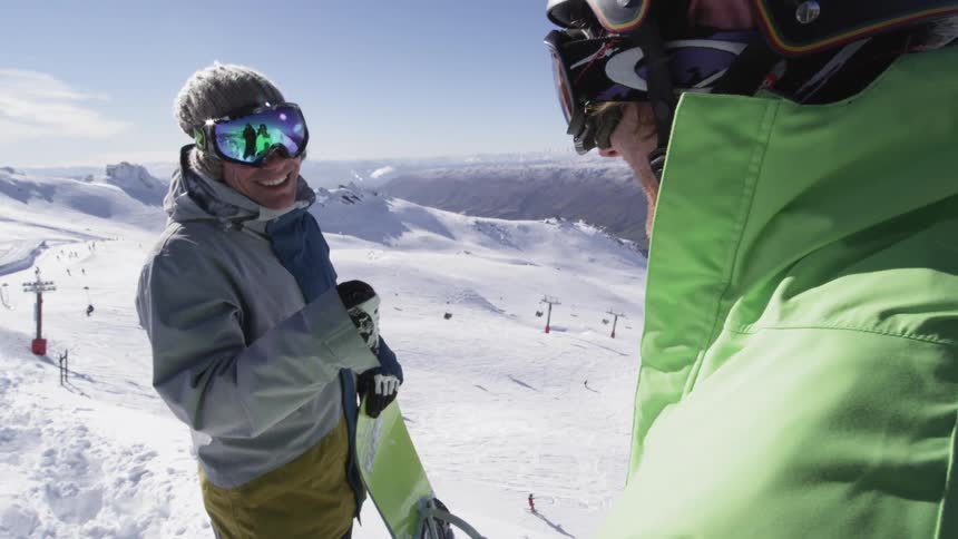 Skiers fist bumping on a mountain