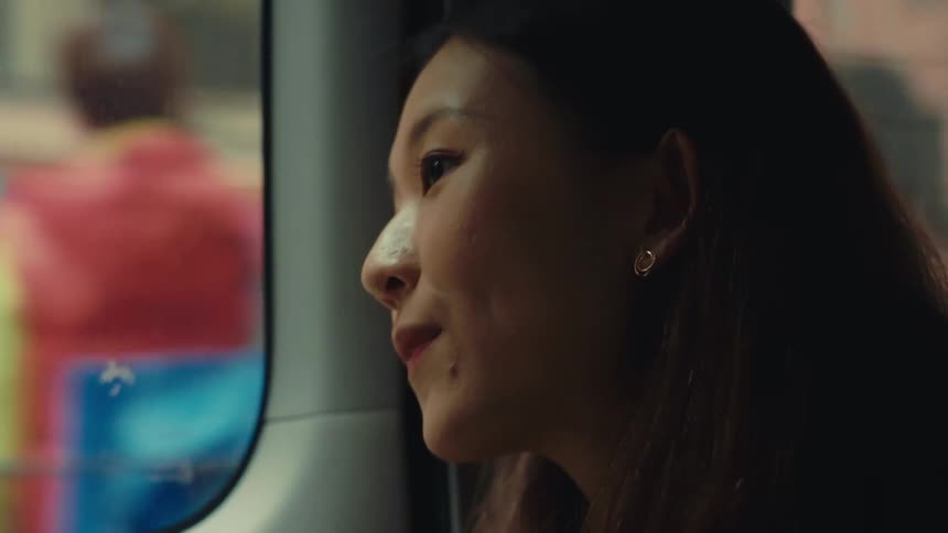 A footage of an asian lady in a vehicle