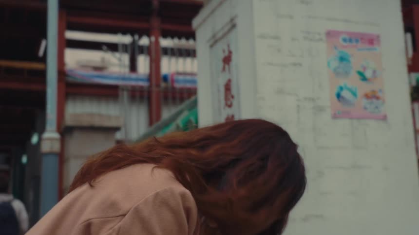 Woman with hands together making prayer sign while lowering her head