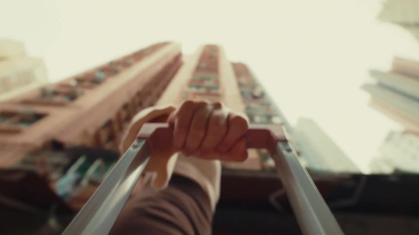 A woman is pulling a piece of luggage in the city