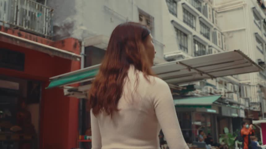 Girl with her back turned walking in a chinese or japanese street