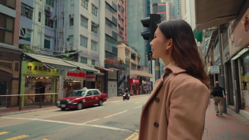 Girl looking toward a busy street in an eastern city