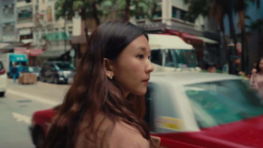 Girl in a big city in traffic trying to cross the street