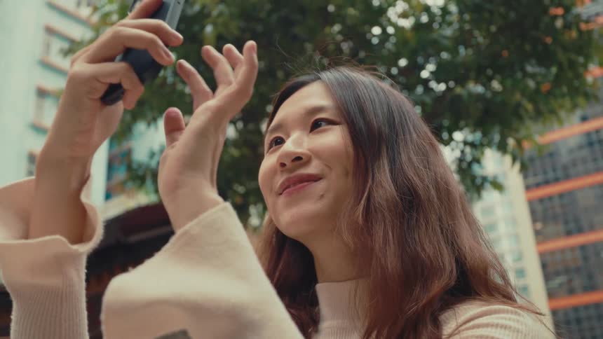 Girl happily taking photos outside