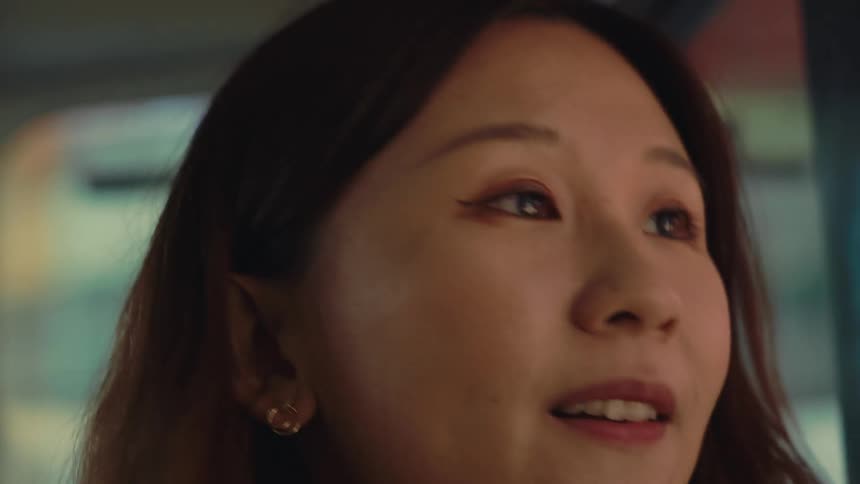 Girl looking happy and smiling inside a public transport