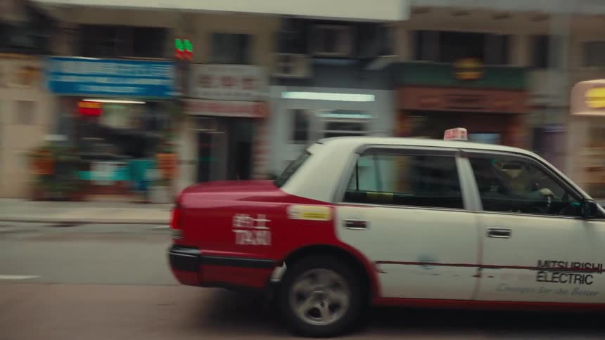The cab drives down the city street