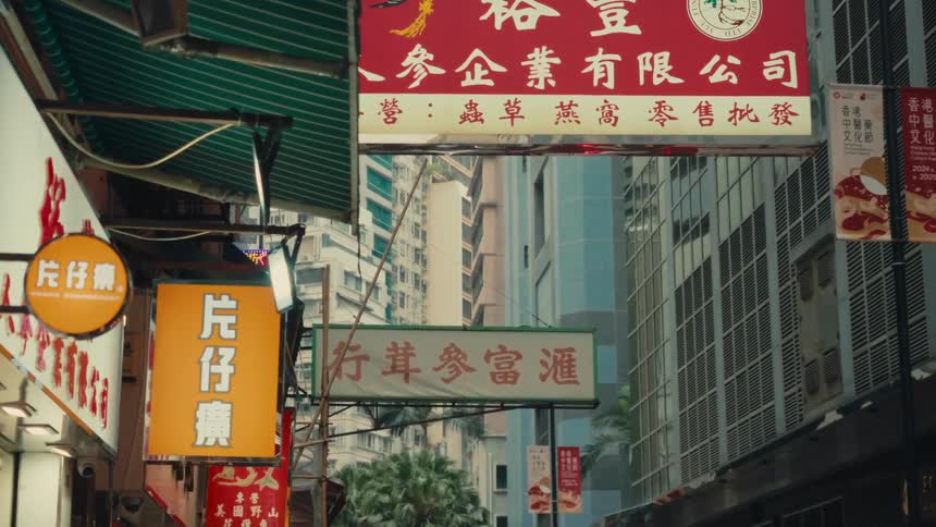 A hong kong street is filled with various vertically oriented colorful commercial signs each adorned with chinese writing hanging and protruding at various heights and showing many services