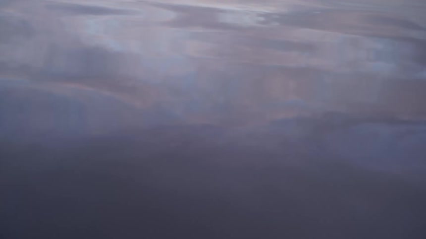 The sky is reflected in windy water