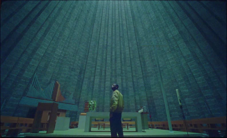 A man looks up in the huge church