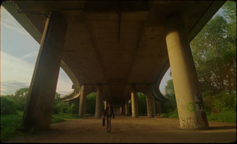A man walks under the overpass