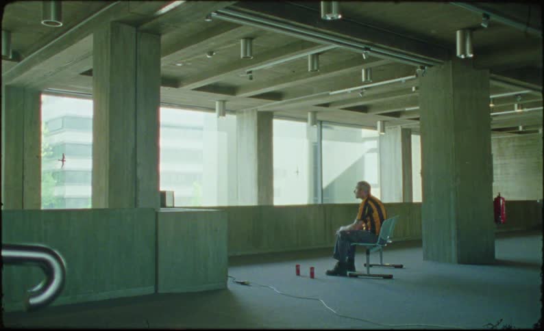 A man is sitting in the hall of the empty building