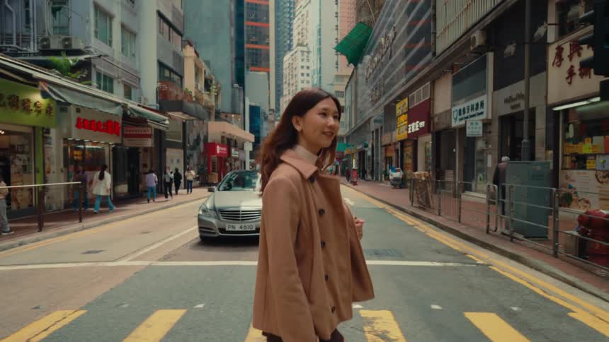 Happy woman crossing the street in a metropolis